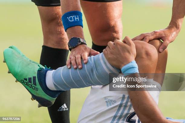 Sporting Kansas City midfielder Roger Espinoza is attended to after taking a foot to the leg during the MLS regular season match between Sporting...