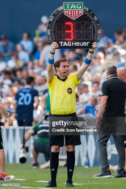 Fourth Official Daniel Radford holds up the board indicating three minutes of stoppage time added during the MLS regular season match between...