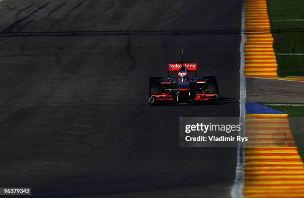 Jenson Button of Great Britain and McLaren drives down the pit lane during winter testing at the Ricardo Tormo Circuit on February 3, 2010 in...