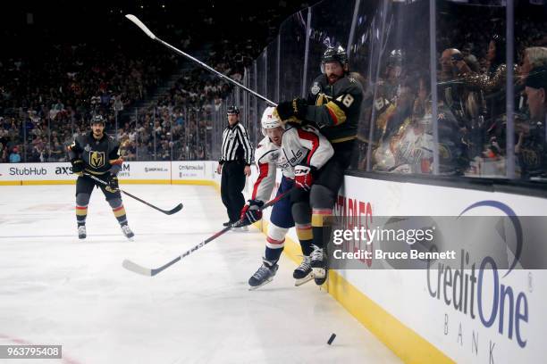 James Neal of the Vegas Golden Knights is checked into the boards by John Carlson of the Washington Capitals during the first period in Game Two of...