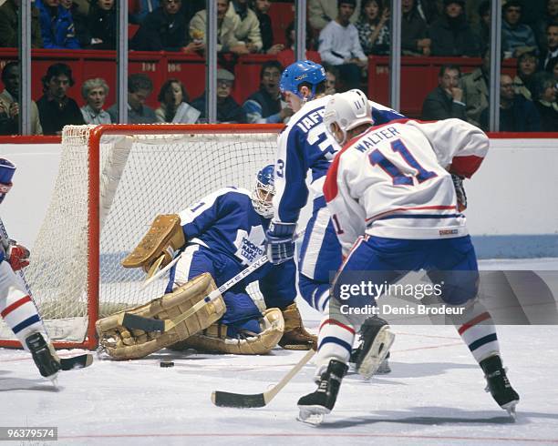 Goaltender Ken Wregget defenseman Albert Iafrate of the Toronto Maple Leafs protects the net against Ryan Walter of the Montreal Canadiens in the...
