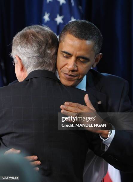 President Barack Obama hugs Senate Majority Leader Harry Reid before his address to the Senate Democratic Policy Committee Issues Conference February...