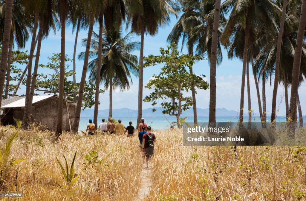 Tourist group walking on Darocotan Island