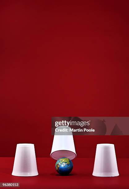 globe under white cup - martin poole stock pictures, royalty-free photos & images