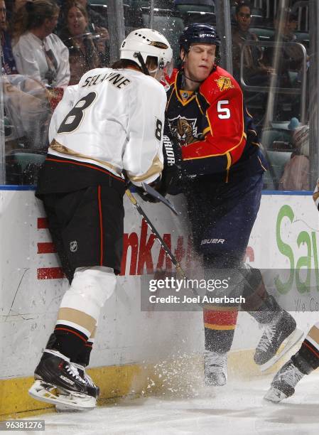 Teemu Selanne of the Anaheim Ducks and Bryan Allen of the Florida Panthers hit the boards behind the Panthers net on February 1, 2010 at the...