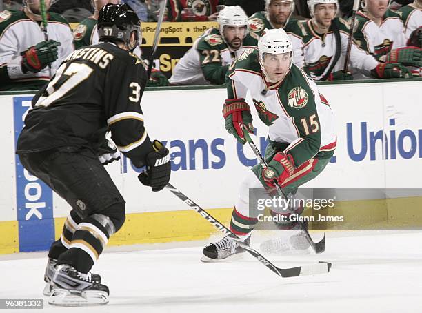 Andrew Brunette of the Minnesota Wild handles the puck against Karlis Skrastins of the Dallas Stars on February 2, 2010 at the American Airlines...