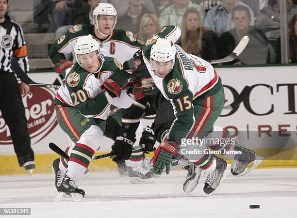 Antti Miettinen and Andrew Brunette of the Minnesota Wild race to the puck against the Dallas Stars on February 2, 2010 at the American Airlines...