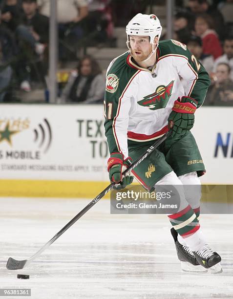 Kyle Brodziak of the Minnesota Wild handles the puck against the Dallas Stars on February 2, 2010 at the American Airlines Center in Dallas, Texas.