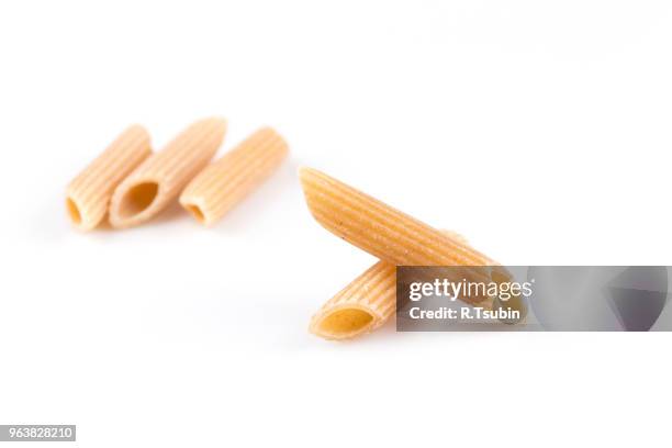 wholemeal pasta penne as close-up shot isolated on white background - vollkorn stock pictures, royalty-free photos & images