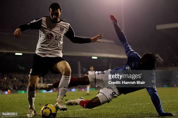 Stephen Kelly of Fulham and Frederic Piquionne of Portsmouth battle for the ball during the Barclays Premier League match between Fulham and...