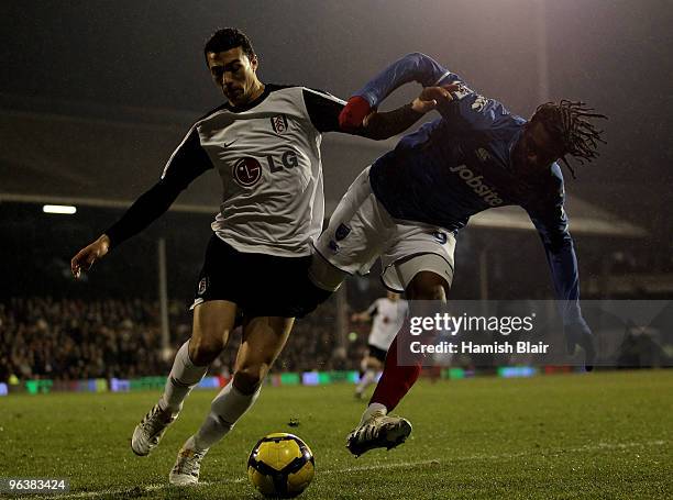 Stephen Kelly of Fulham and Frederic Piquionne of Portsmouth battle for the ball during the Barclays Premier League match between Fulham and...