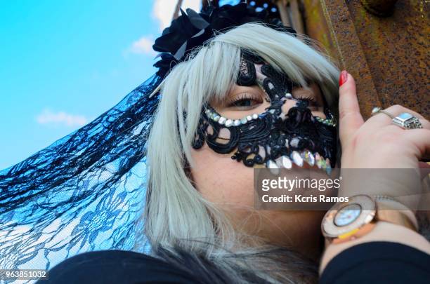 high resolution photography of historic city young caucasian woman dressed in black mask representing death, blue eyed and white haired wig in the mysterious and cloudy city, at a convention of witches and magicians, in the historical and tourist city of - halloween in sao paulo stock-fotos und bilder
