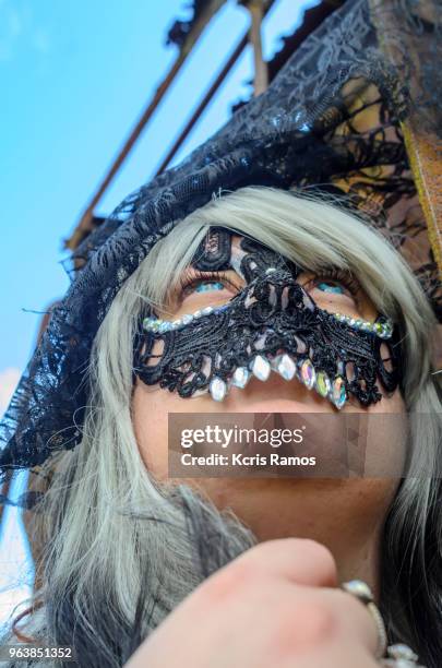 high resolution photography of historic city young caucasian woman dressed in black mask representing death, blue eyed and white haired wig in the mysterious and cloudy city, at a convention of witches and magicians, in the historical and tourist city of - halloween in sao paulo stock-fotos und bilder