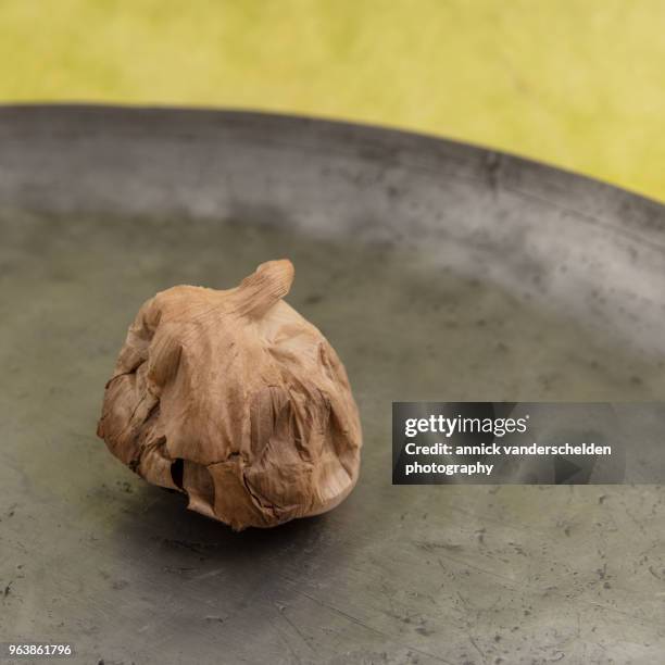 black garlic. - pewter stock pictures, royalty-free photos & images
