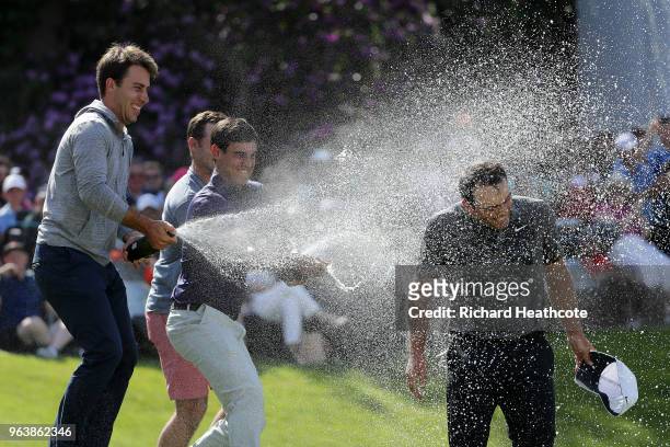 Francesco Molinari of Italy is sprayed with champagne after victory in the final round of the BMW PGA Championship at Wentworth on May 27, 2018 in...
