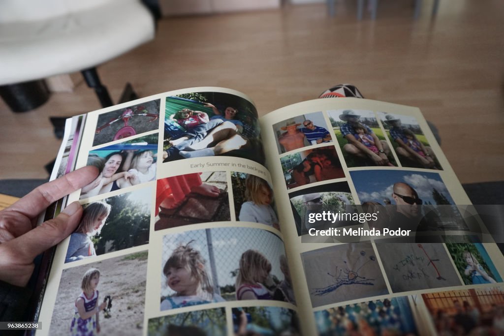 Person holding a photo album created and printed with online software