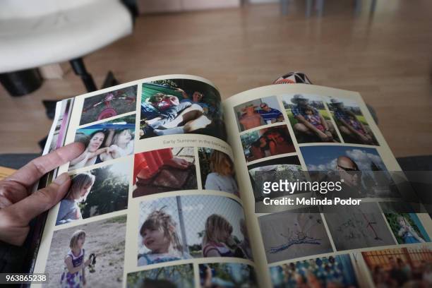 person holding a photo album created and printed with online software - scrapbook stock pictures, royalty-free photos & images