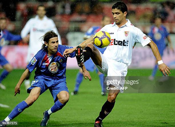 Sevilla's Brazilian midfielder Renato competes with Getafe's defender David Cortes during a Spanish King�s Cup football match at Sanchez Pizjuan...