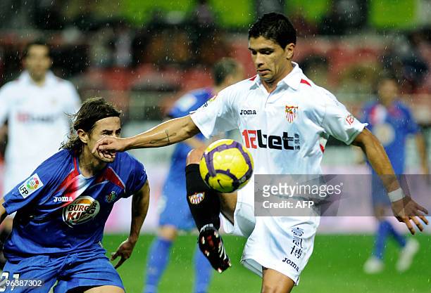 Sevilla's Brazilian midfielder Renato competes with Getafe's defender David Cortes during a Spanish King�s Cup football match at Sanchez Pizjuan...