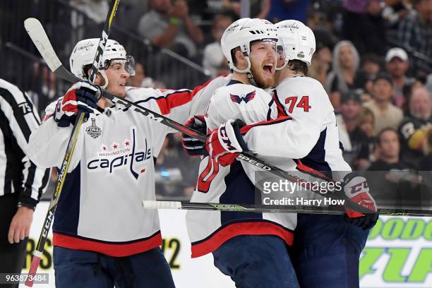 Lars Eller of the Washington Capitals is congratulated by his teammates Andre Burakovsky and John Carlson after scoring a first-period goal against...