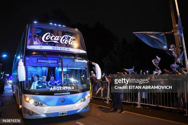 Argentina's national football team supporters bid farewell to their players outside the Argentine Football Association training facilities in Ezeiza,...