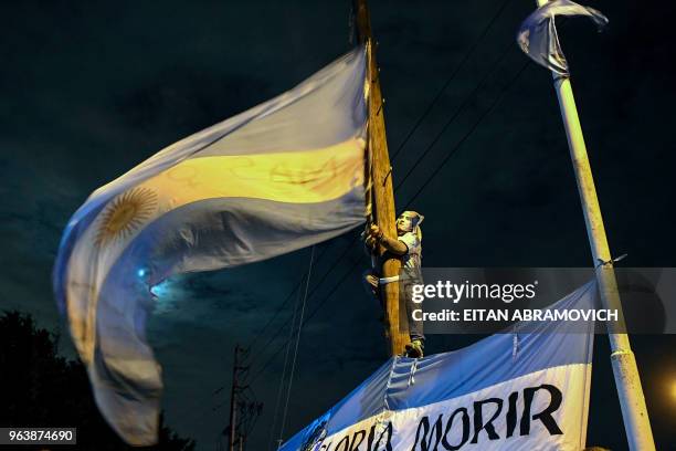 An Argentina's national football team supporter bids farewell to the players outside the Argentine Football Association training facilities in...