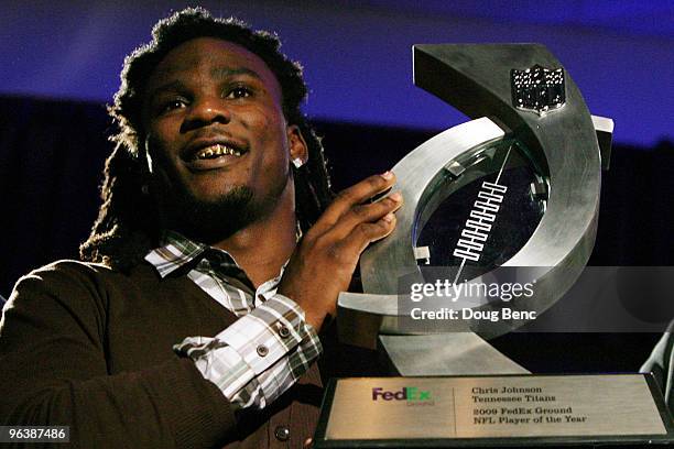 Chris Johnson of the Tennessee Titans smiles with his award after being named the FedEx Ground NFL Player of the Year at a press conference held at...