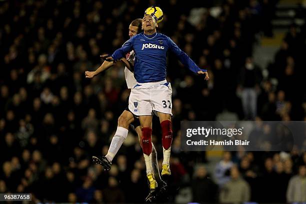Brede Hangeland of Fulham and Hassan Yebda of Portsmouth battle for the header during the Barclays Premier League match between Fulham and Portsmouth...
