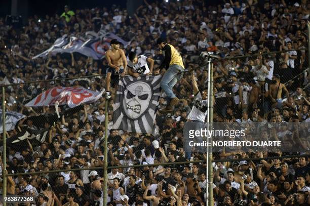 Fans of Olimpia celebrate after their team defeated Libertad by 2-1 to win the Paraguayan Apertura football tournament, at the Defensores del Chaco...