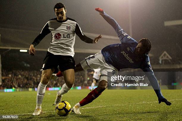 Stephen Kelly of Fulham and Frederic Piquionne of Portsmouth battle for the ball during the Barclays Premier League match between Fulham and...