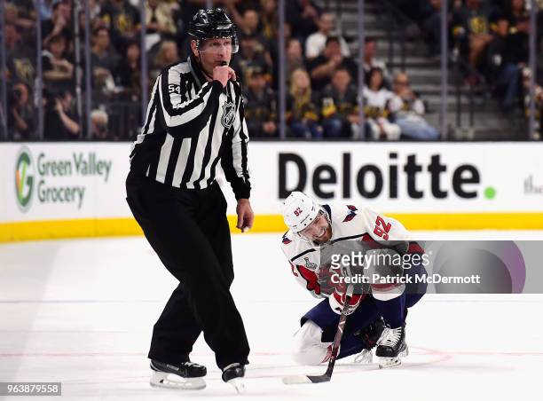 Linesman Greg Devorski blows his whistle as Evgeny Kuznetsov of the Washington Capitals reacts after being checked by Brayden McNabb s of the Vegas...