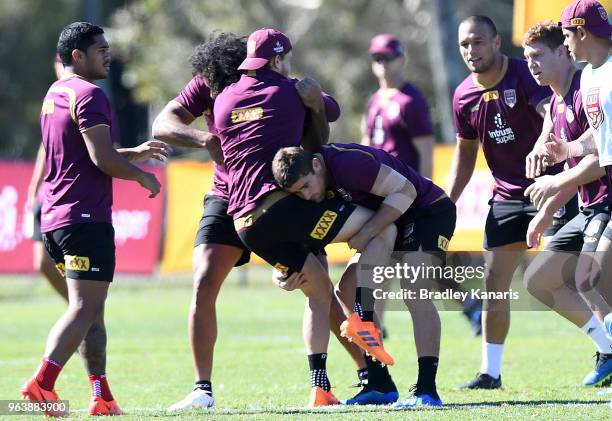 Cameron Munster is tackled by Andrew McCullough during a Queensland Maroons training session at Sanctuary Cove on May 31, 2018 at the Gold Coast,...