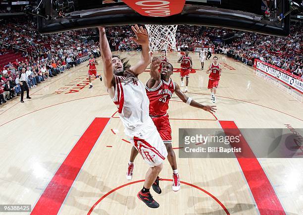 Luis Scola of the Houston Rockets shoots a layup against Jodie Meeks of the Milwaukee Bucks during the game at Toyota Center on January 18, 2010 in...