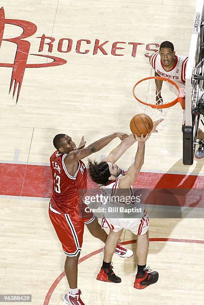 Luis Scola of the Houston Rockets shoots a layup against Jodie Meeks of the Milwaukee Bucks during the game at Toyota Center on January 18, 2010 in...