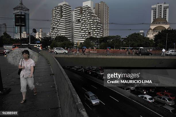 Woman takes her way as heavy rain starts near Paraiso subway station, in Sao Paulo, Brazil, on February 3, 2010. Today has completed the 43rd...
