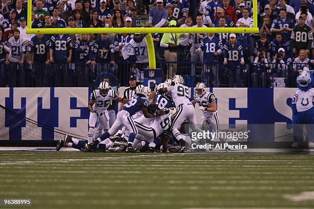 Quarterback Peyton Manning of the Indianapolis Colts is stopped on the Goal Line by Linebacker Calvin pace of the New York Jets when the Indianapolis...