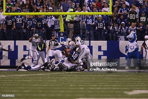 Quarterback Peyton Manning of the Indianapolis Colts is stopped on the Goal Line by Linebacker Calvin pace of the New York Jets when the Indianapolis...