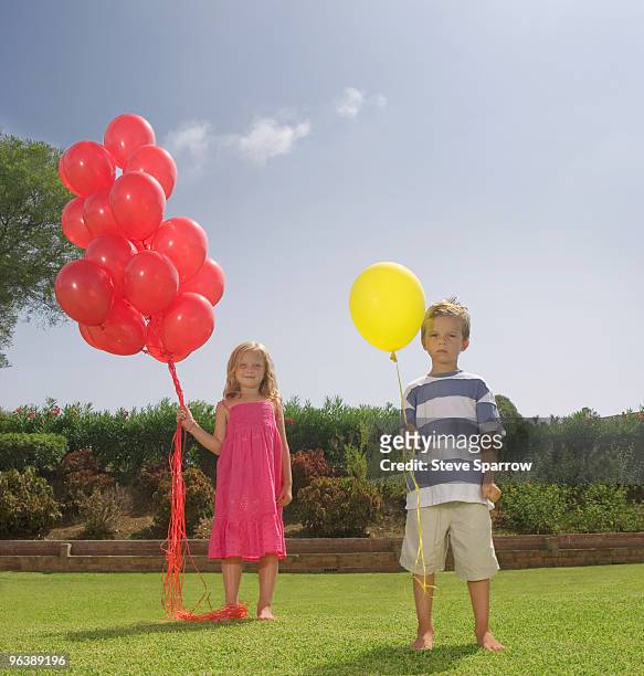 young children holding red balloons - brother jealous stock pictures, royalty-free photos & images