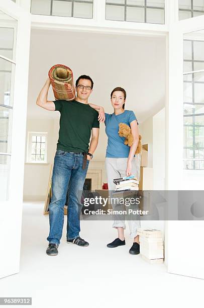 a couple posing with packed belongings - teddy bear rug stock pictures, royalty-free photos & images