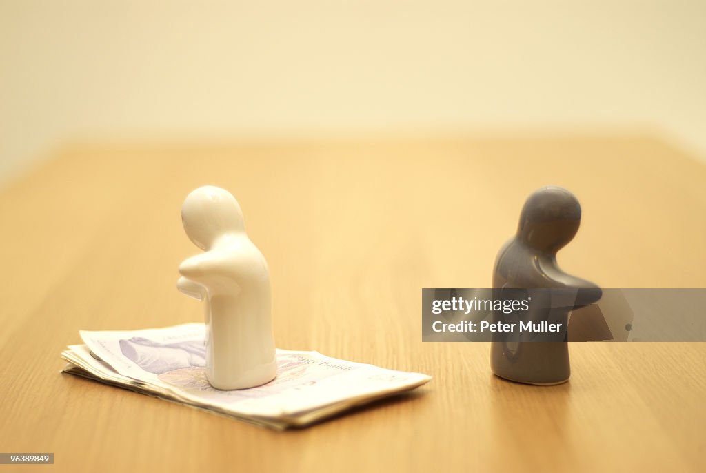 Small figures, one on money