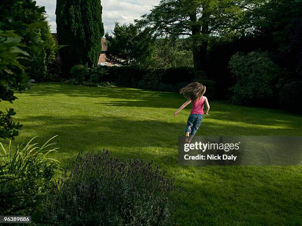 a young girl running in a garden - kids bare feet grass stock pictures, royalty-free photos & images