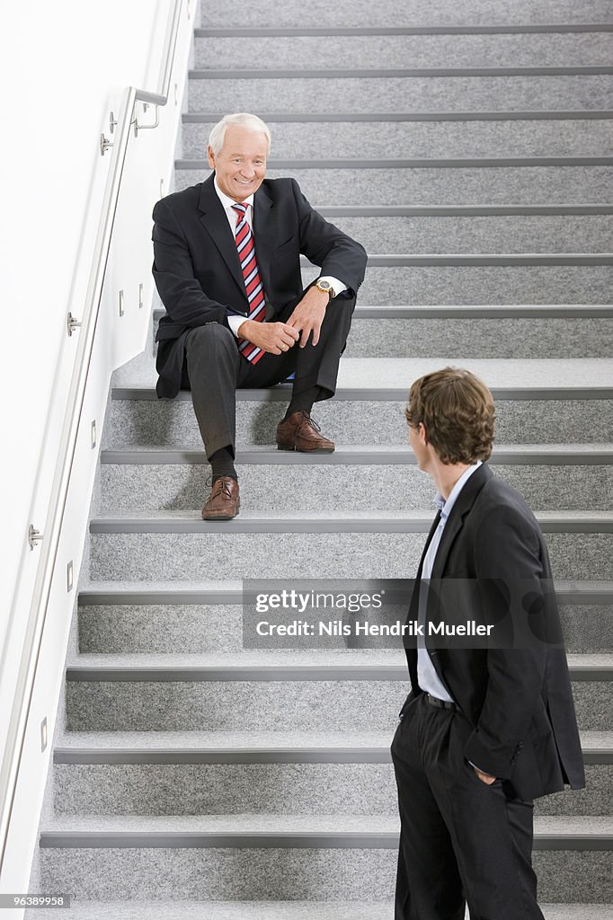 Two businessmen on staircase