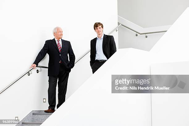 two businessmen on staircase - 2 steps stock-fotos und bilder