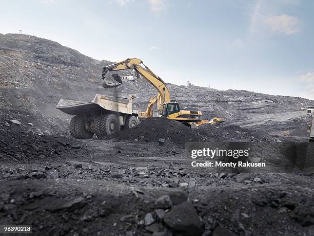 digger working in coal mine - mines de charbon photos et images de collection