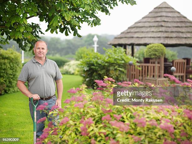 gardener with spade in garden - ground staff stock pictures, royalty-free photos & images