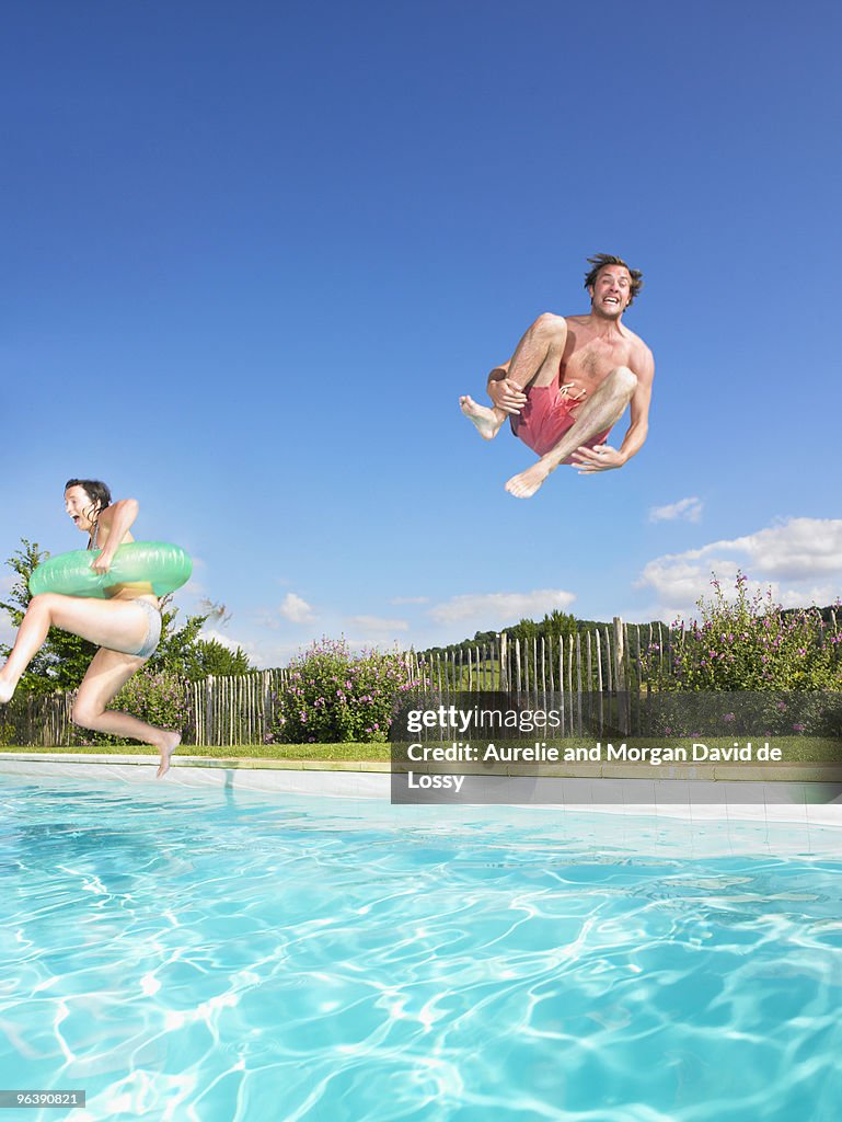 People jumping into pool