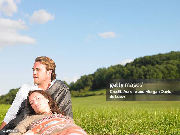 young people lying in field - david de lossy sleep stock pictures, royalty-free photos & images