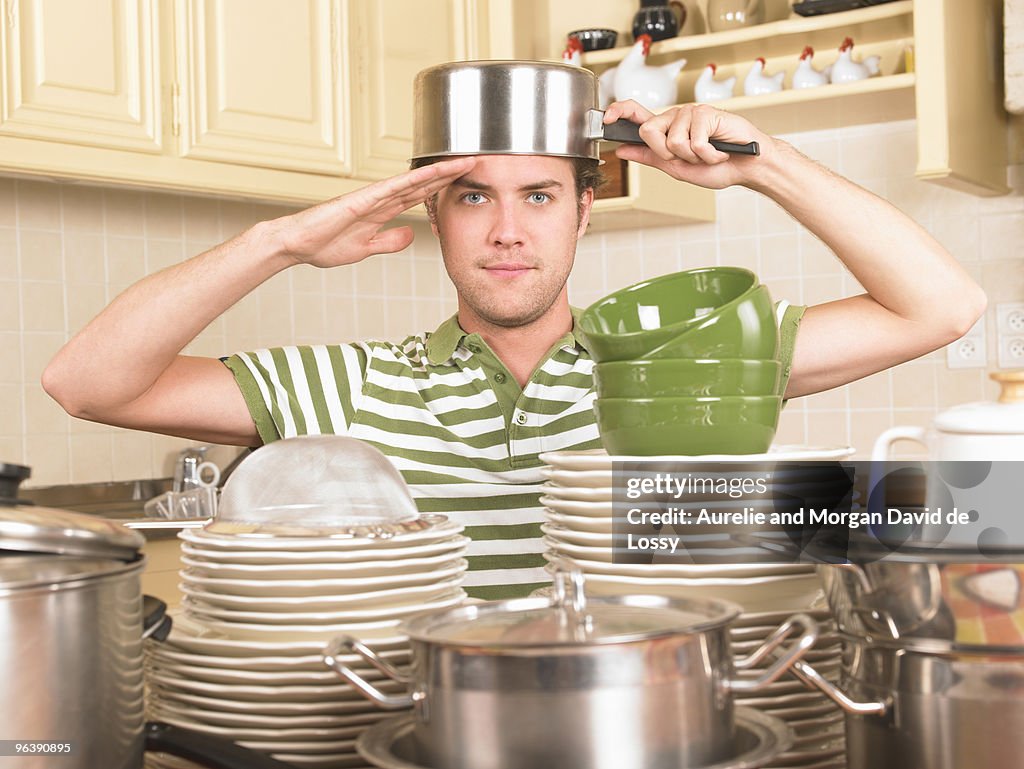 Young man with pan on head