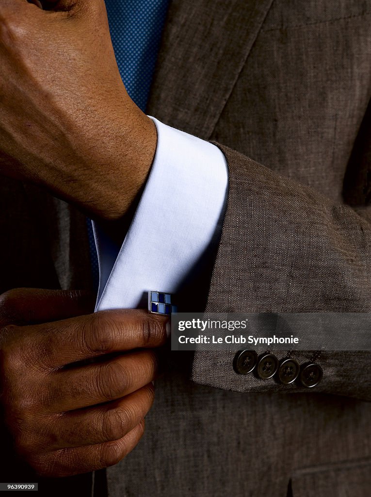 Business man adjusting cuff links