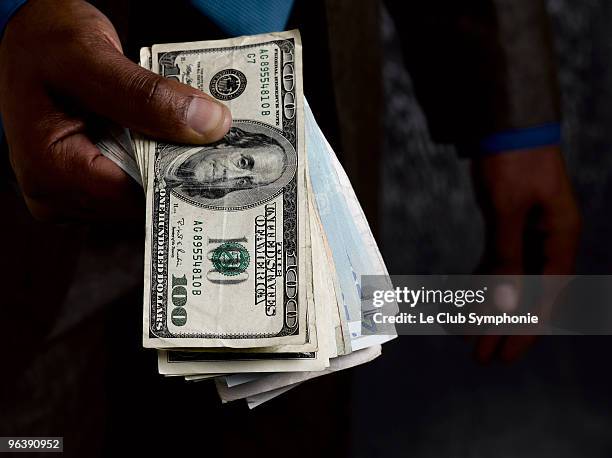 business man holding out dollar bills - 50 dollars stock pictures, royalty-free photos & images